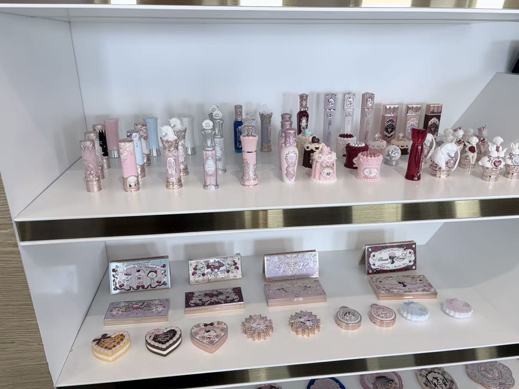 Haiming showroom — vintage embossed lipstick tubes and compacts custom-made for global indie brands